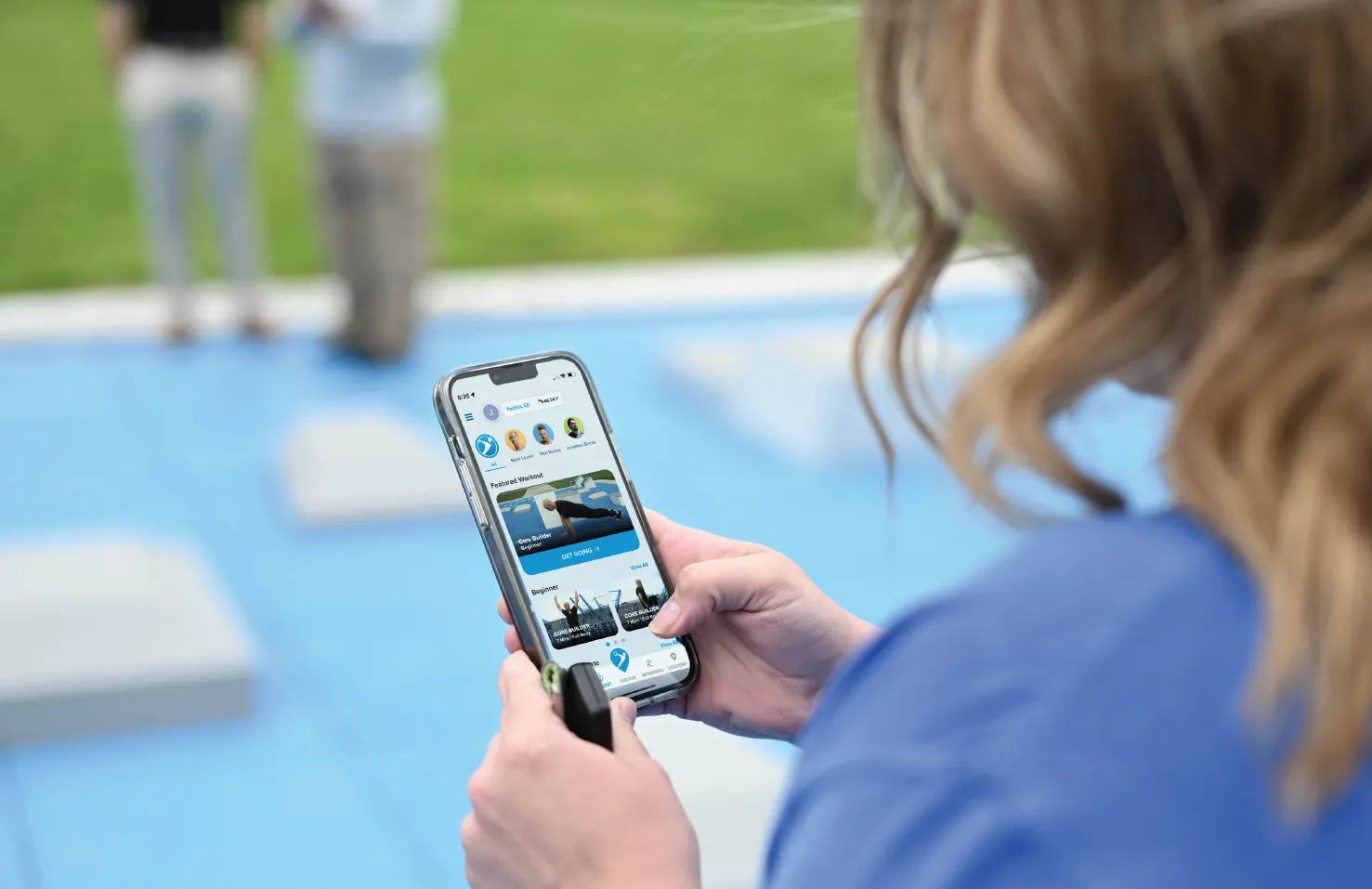 girl looking at Fitness Court App homescreen on her mobile phone