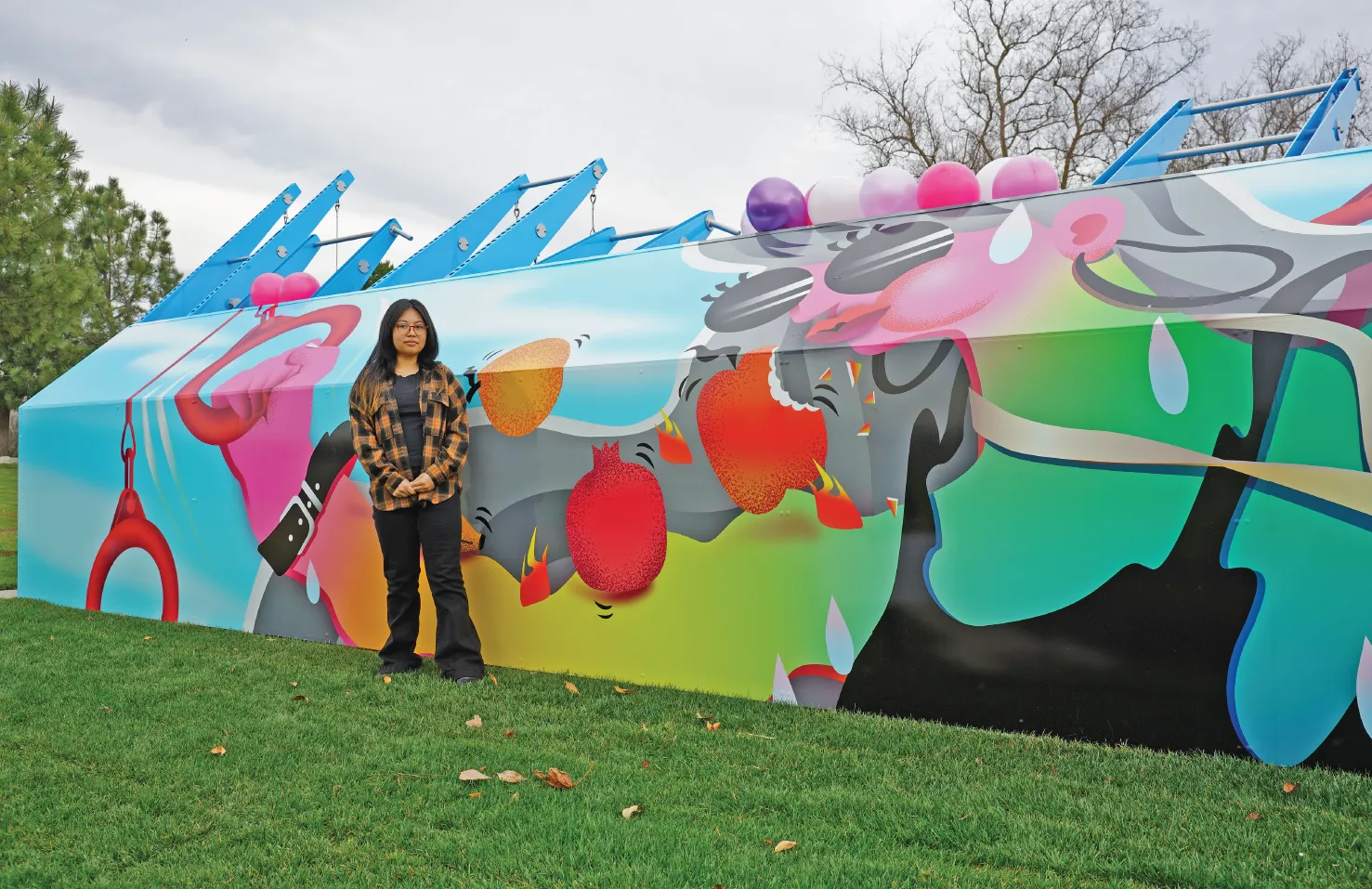 artist in front of their work on the Fitness Court